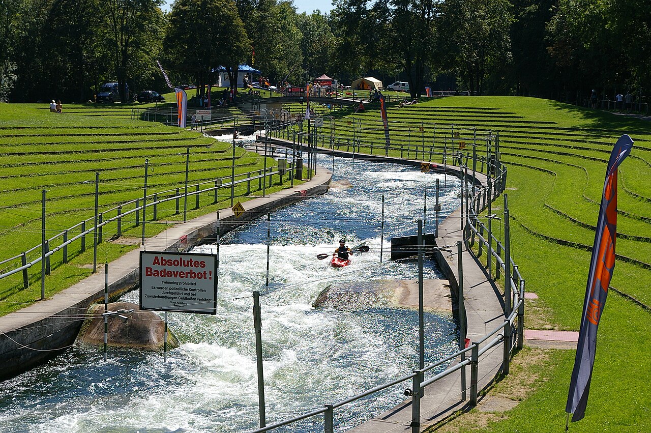 Augsburg Eiskanal, with water, kayaker passing Corkscrew and entering Carousel