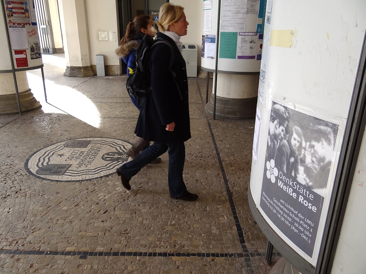 Visitors Walk Past White Rose Poster at Entrance to Main Building of Ludwig-Maximilians-Universitat - Munich - Germany
