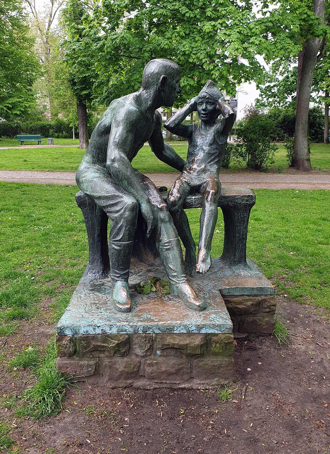 Sculpture, " Grenzsoldat mit Kind " by Gerhard Rommel , 1971, Bleichröderpark, Berlin-Pankow , Germany