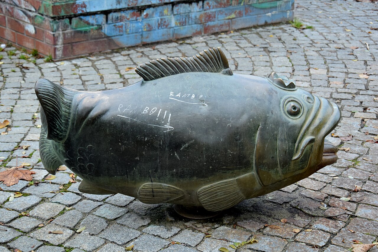 Bronze figure Fish by Hans-Peter Goettsche on the water playground in Clara-Zetkin-Park in Berlin-Marzahn, Germany