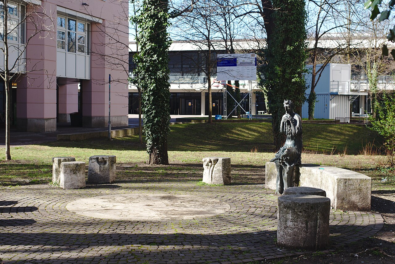 Statue of pan with seating group close to the building of the student administration in the Leopoldstraße, Munich